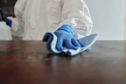 person cleaning table