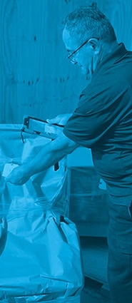 worker scanning tag on box