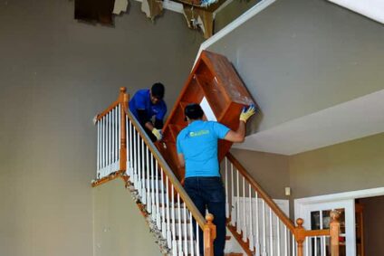 Associates carrying out a bookshelf