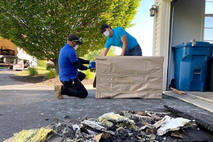Blue Kangaroo Packoutz team packing up items from a burned house
