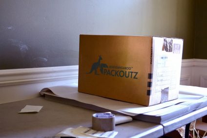 Cardboard box on a table with packing tape