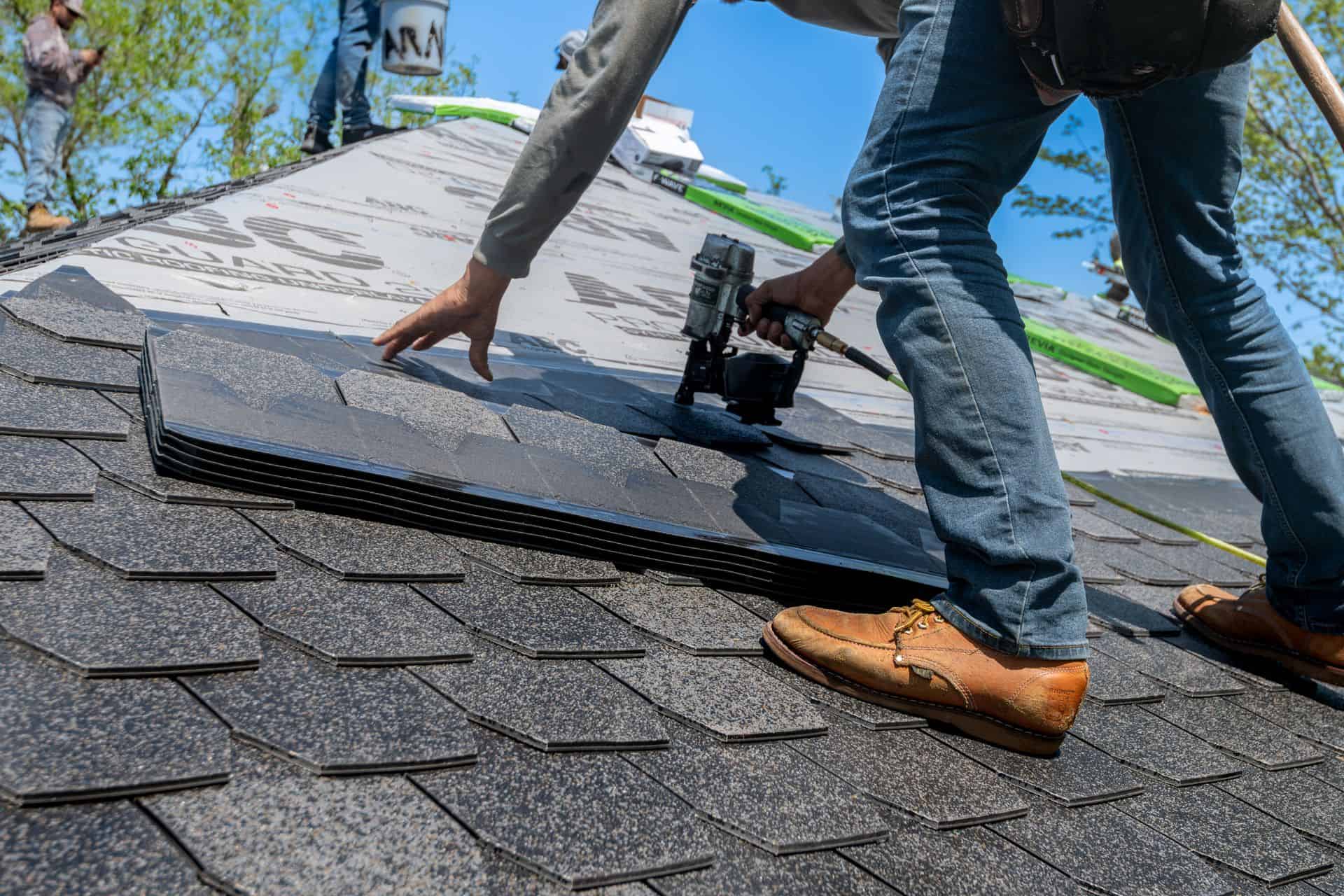 A restoration contractor repairing a roof after storm damage.