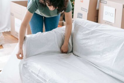 furniture being covered with protective material during a contents packout.